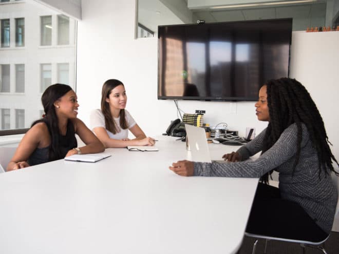 Three co-workers working at a table together