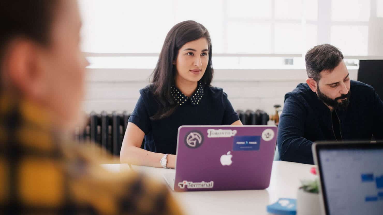 Woman working on her laptop in a meeting