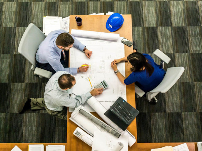 Three coworkers working at a table together