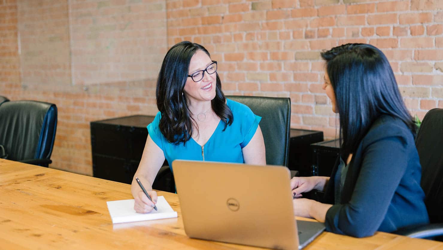 Two women working together at a table