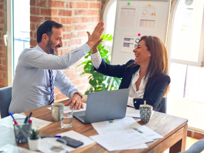 Co-workers giving each other a high-five