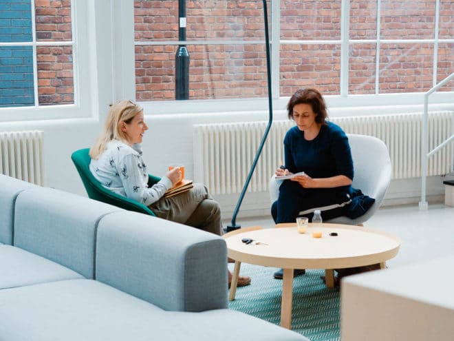 Co-workers chatting on a couch