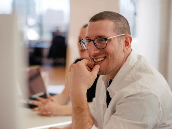 Man smiling during a meeting