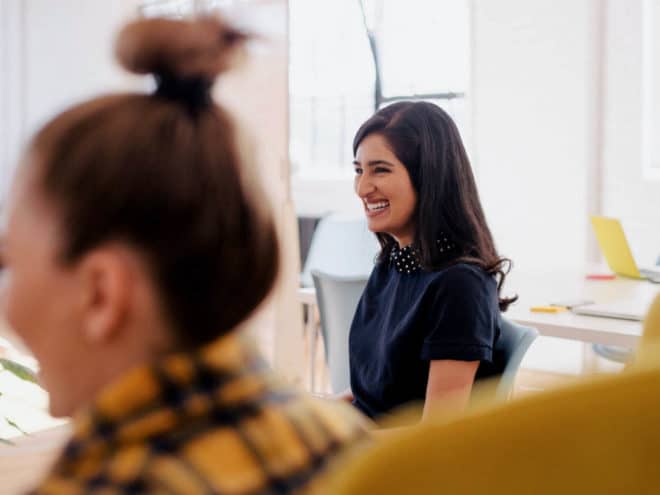 Woman smiling at a meeting