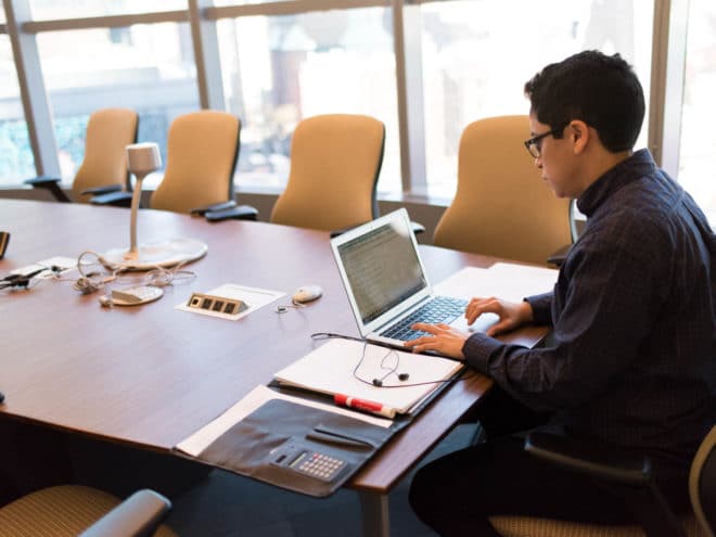 Man working on a laptop in a conference room