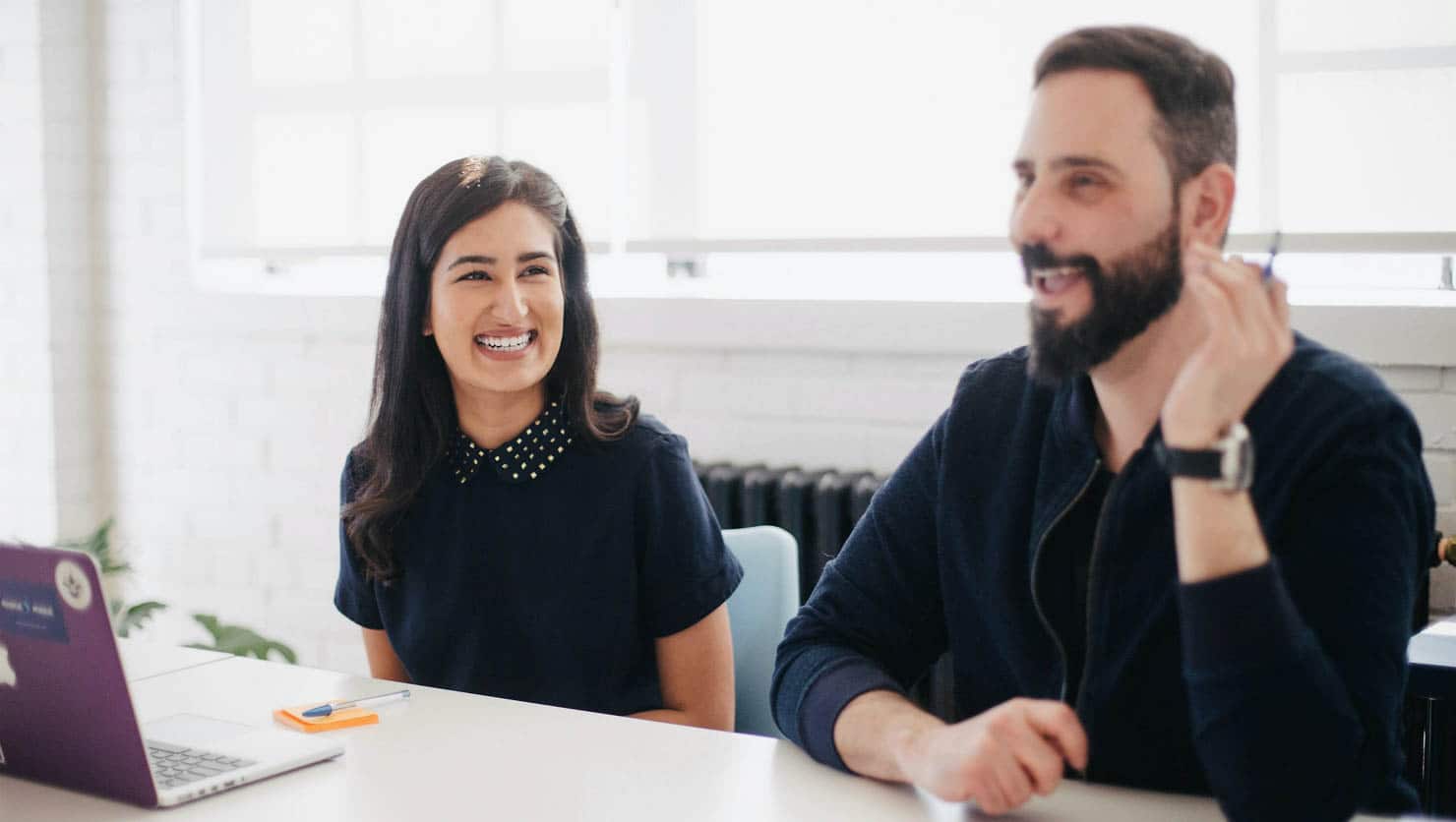 Woman and man smiling at meeting