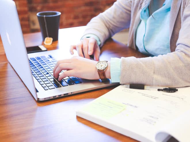 Person working on a laptop at a desk